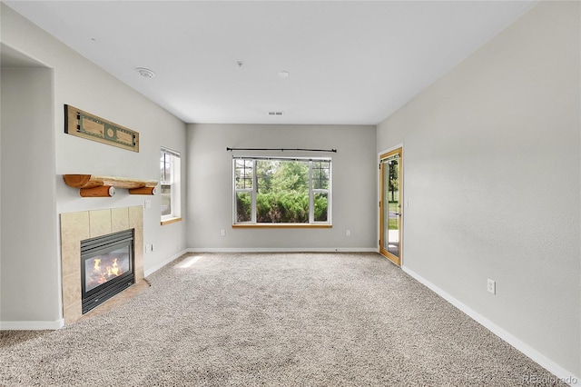 5220 Boardwalk Dr Unit A14, Fort Collins, CO 80525 - unfurnished living room featuring carpet and a tiled fireplace