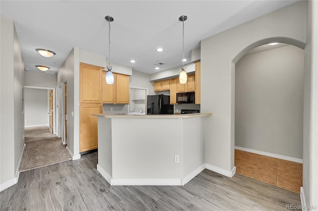 5220 Boardwalk Dr Unit A14, Fort Collins, CO 80525 - kitchen featuring black appliances, arched walkways, light wood finished floors, decorative light fixtures, and recessed lighting