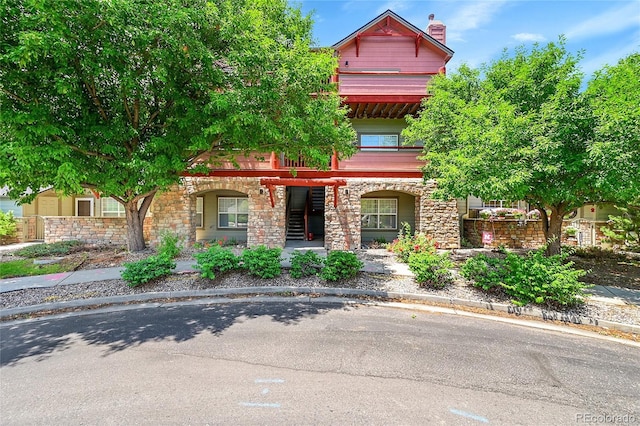 5220 Boardwalk Dr Unit A14, Fort Collins, CO 80525 - view of property hidden behind natural elements featuring stone siding and a porch