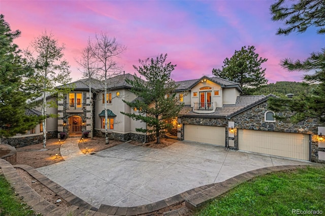 22554 Treetop Ln, Golden, CO 80401 - view of front of property with stone siding, stucco siding, a tile roof, and concrete driveway