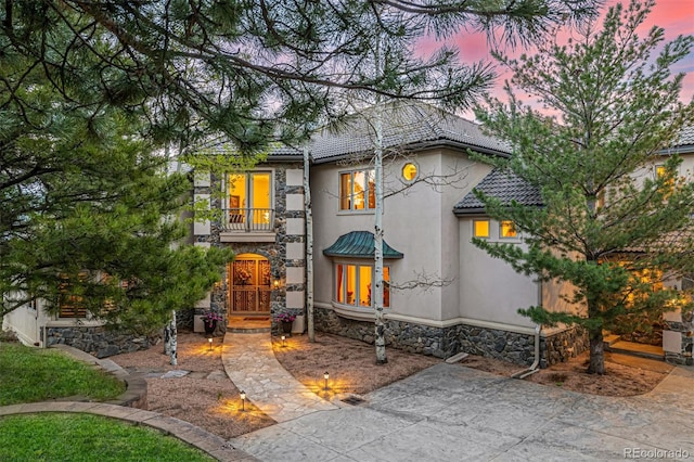 22554 Treetop Ln, Golden, CO 80401 - view of front of property featuring a balcony, stone siding, stucco siding, and a tile roof