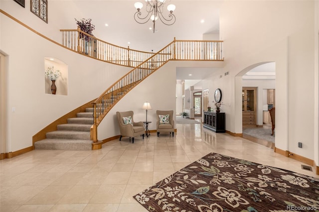 22554 Treetop Ln, Golden, CO 80401 - foyer with a towering ceiling, stairway, baseboards, light tile patterned floors, and a chandelier