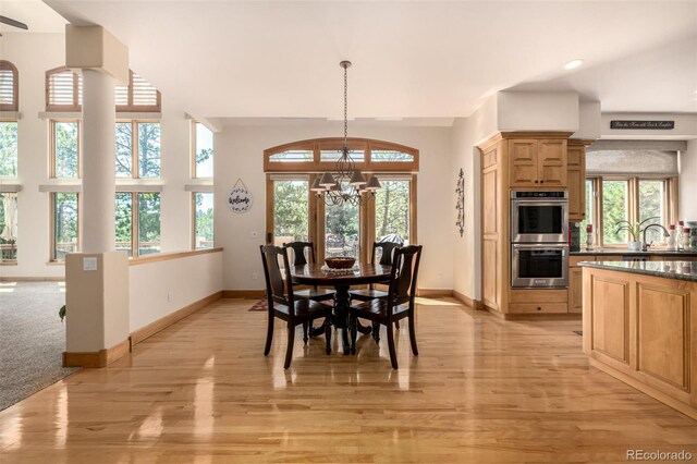 22554 Treetop Ln, Golden, CO 80401 - dining room featuring a chandelier, healthy amount of natural light, baseboards, light wood-style flooring, and recessed lighting