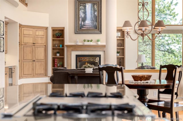 22554 Treetop Ln, Golden, CO 80401 - living room with a chandelier, a lit fireplace, and beverage cooler