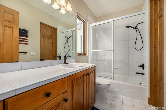 22554 Treetop Ln, Golden, CO 80401 - full bath with tile patterned floors, toilet, vanity, and combined bath / shower with glass door