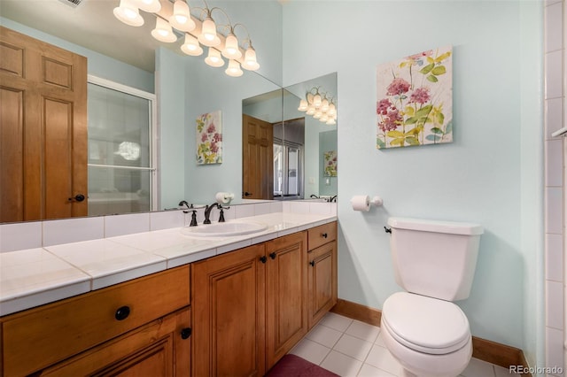 22554 Treetop Ln, Golden, CO 80401 - full bath featuring toilet, baseboards, a shower stall, tile patterned flooring, and vanity
