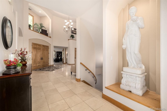 22554 Treetop Ln, Golden, CO 80401 - foyer with light tile patterned floors, baseboards, and a chandelier