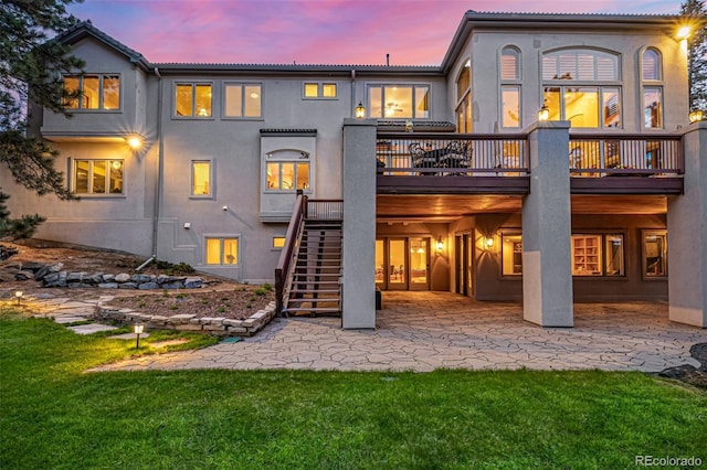 22554 Treetop Ln, Golden, CO 80401 - rear view of house featuring a patio, stucco siding, stairs, a deck, and a lawn