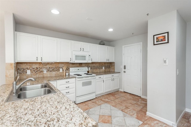 kitchen featuring white appliances, white cabinetry, sink, and decorative backsplash