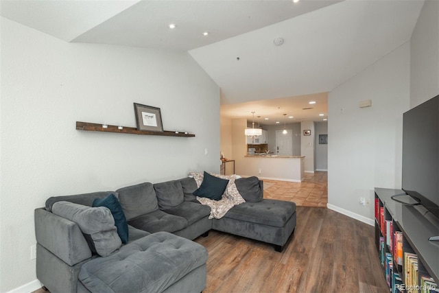 living room featuring wood-type flooring and lofted ceiling