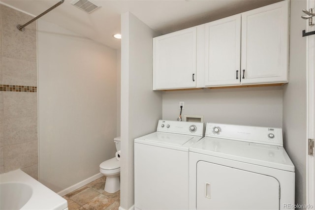 clothes washing area featuring light tile patterned flooring and washer and clothes dryer