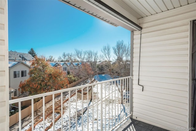 view of snow covered back of property