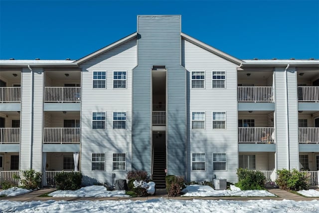 snow covered property with cooling unit