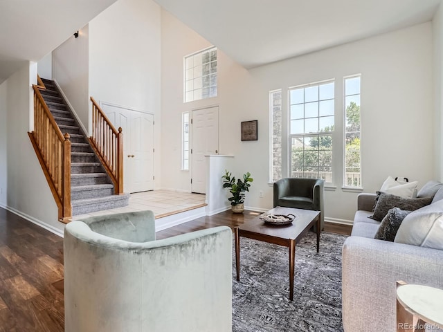 21770 Mount Elbert Pl, Parker, CO 80138 - living room with dark wood-type flooring, stairs, healthy amount of natural light, and a towering ceiling