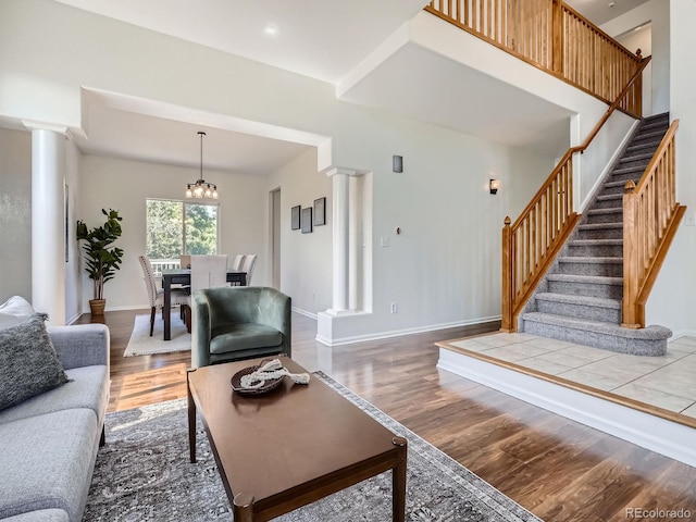 21770 Mount Elbert Pl, Parker, CO 80138 - living area with ornate columns, wood finished floors, and stairway