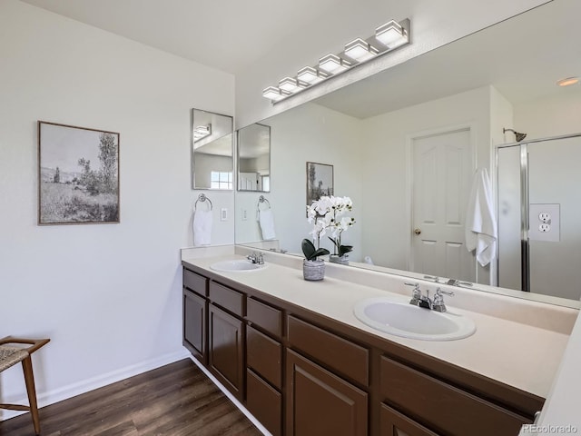 21770 Mount Elbert Pl, Parker, CO 80138 - bathroom featuring double vanity, wood finished floors, and an enclosed shower