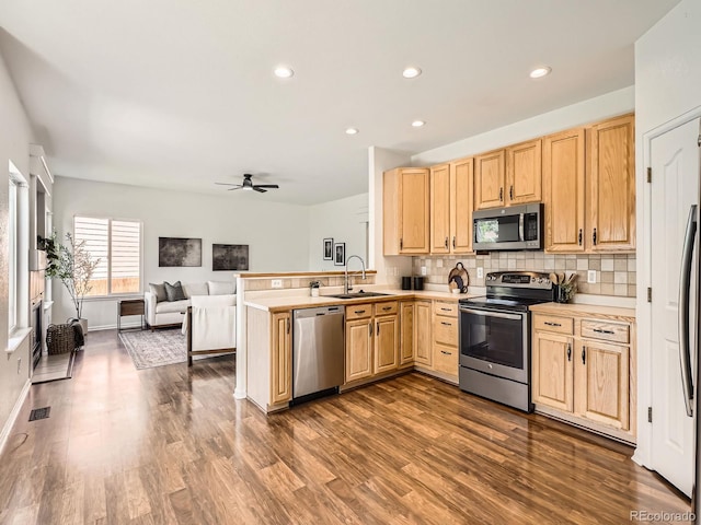 21770 Mount Elbert Pl, Parker, CO 80138 - kitchen with stainless steel appliances, light brown cabinetry, a peninsula, and recessed lighting