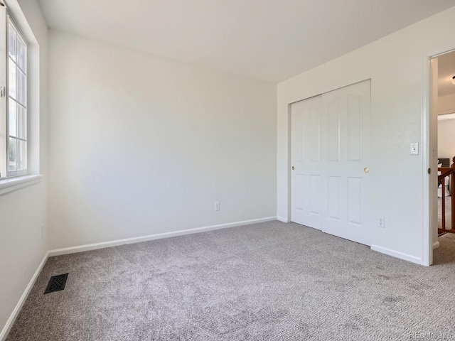 21770 Mount Elbert Pl, Parker, CO 80138 - unfurnished bedroom featuring carpet, multiple windows, and a closet