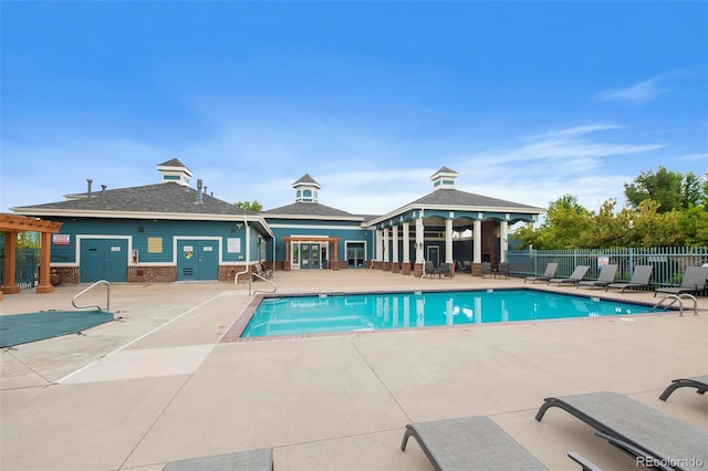 community pool with a gazebo, a patio area, and fence