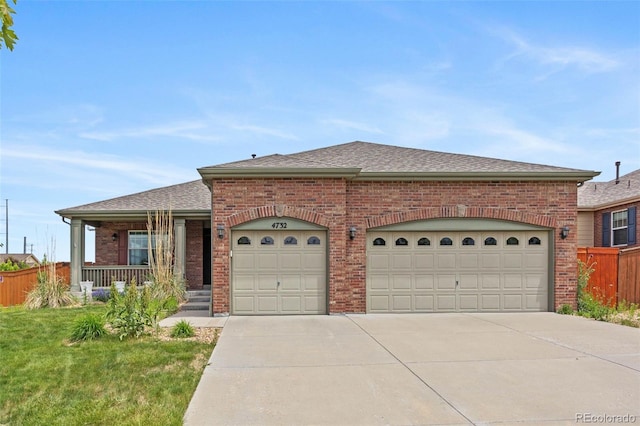 4732 S Coolidge St, Aurora, CO 80016 - view of front of home with brick siding, a shingled roof, concrete driveway, and an attached garage
