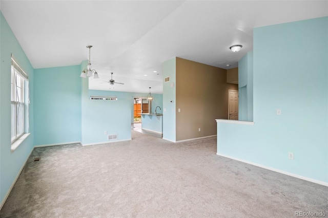 4732 S Coolidge St, Aurora, CO 80016 - unfurnished living room featuring carpet, a ceiling fan, a chandelier, and vaulted ceiling