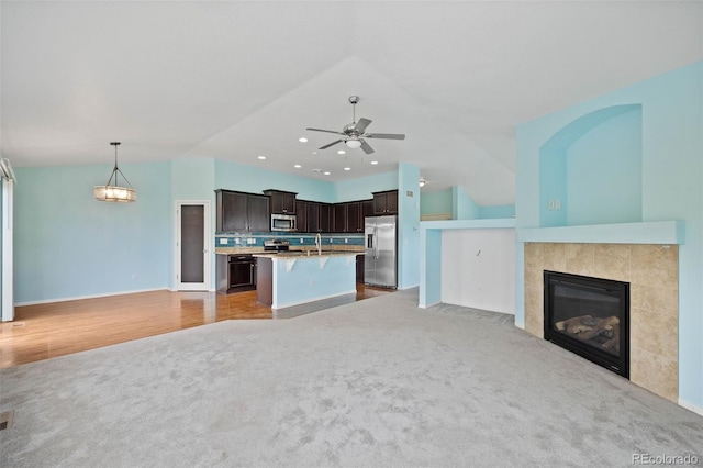 4732 S Coolidge St, Aurora, CO 80016 - kitchen featuring stainless steel appliances, open floor plan, light carpet, dark brown cabinetry, and recessed lighting