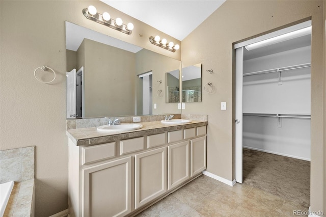 4732 S Coolidge St, Aurora, CO 80016 - bathroom with double vanity, a walk in closet, and lofted ceiling