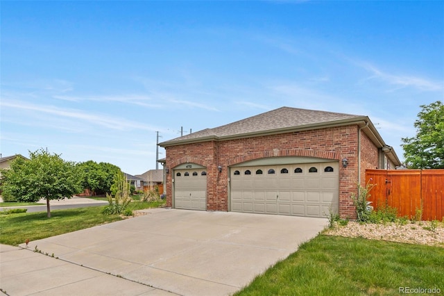 4732 S Coolidge St, Aurora, CO 80016 - view of home's exterior featuring brick siding, driveway, a garage, and a shingled roof