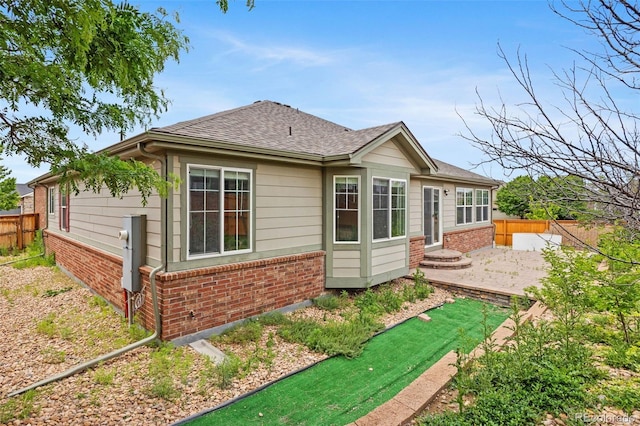 4732 S Coolidge St, Aurora, CO 80016 - back of house featuring brick siding, a patio, and a shingled roof