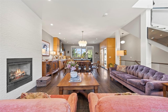 living room with a chandelier and dark hardwood / wood-style flooring