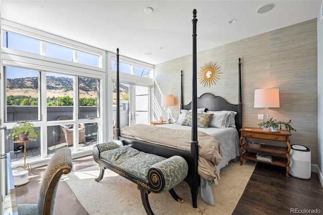 bedroom featuring a mountain view and hardwood / wood-style flooring