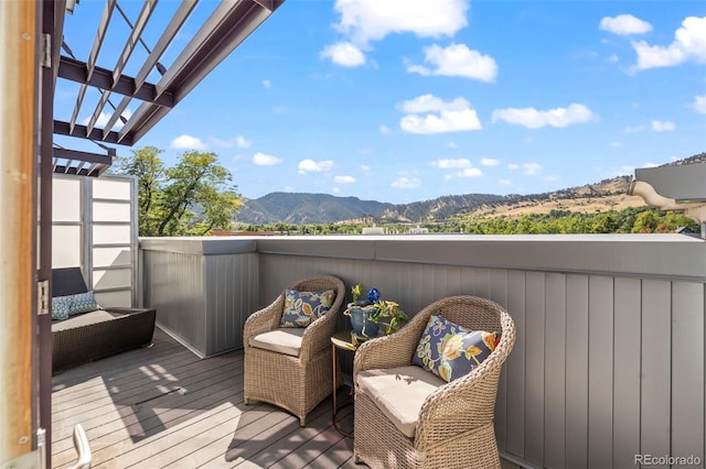 deck with a pergola and a mountain view