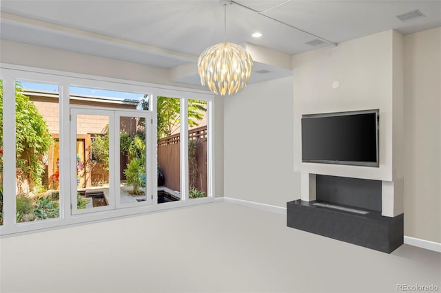 unfurnished living room with an inviting chandelier