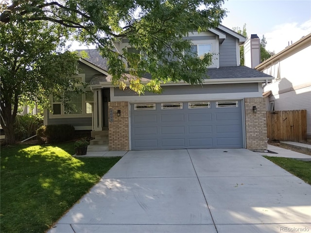 view of front of home featuring a garage and a front lawn