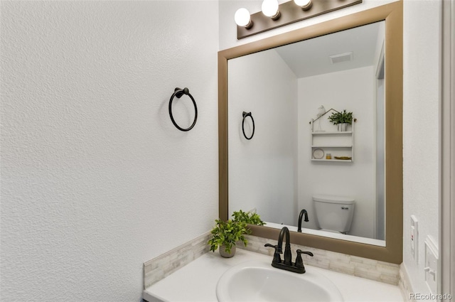 bathroom featuring sink and toilet