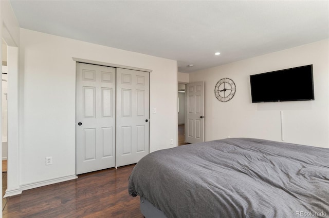 bedroom with a closet and dark wood-type flooring