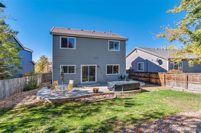 rear view of property with a patio area and a yard