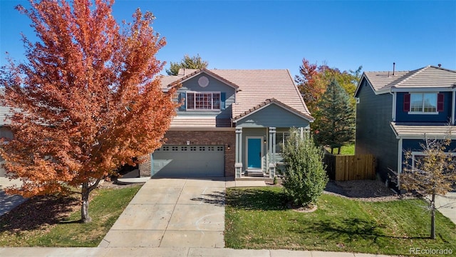 view of front of home with a front lawn and a garage