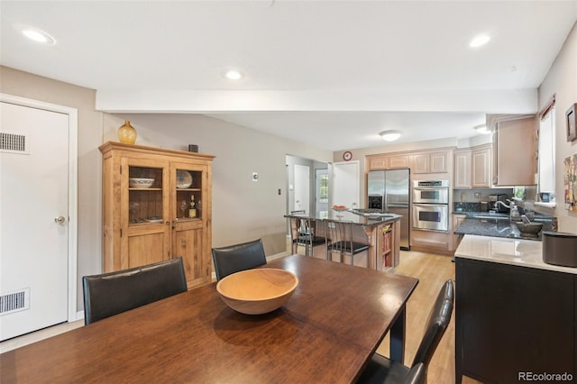 dining room featuring light hardwood / wood-style flooring and sink