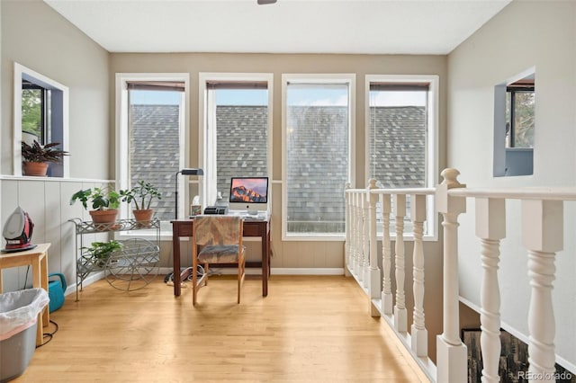 living area featuring a wealth of natural light and light hardwood / wood-style floors