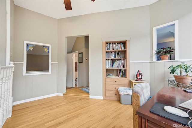 office with light hardwood / wood-style flooring and ceiling fan