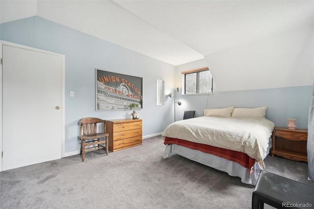 bedroom with carpet flooring and vaulted ceiling