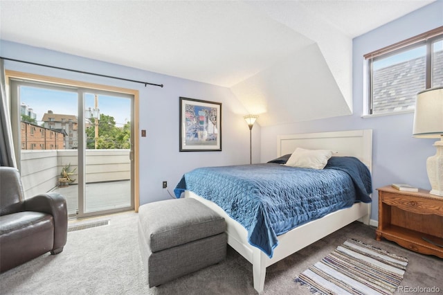 carpeted bedroom with lofted ceiling and access to outside