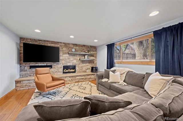 living area with a fireplace, recessed lighting, and wood finished floors