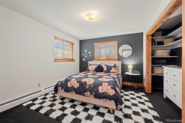 bedroom featuring baseboards, carpet floors, and a baseboard radiator