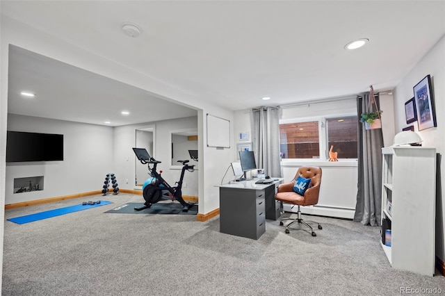 carpeted office space with a baseboard heating unit, recessed lighting, and baseboards