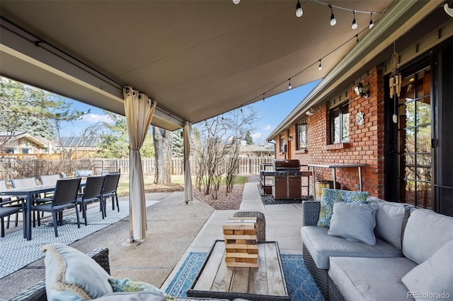 view of patio with outdoor dining space, a fenced backyard, and outdoor lounge area