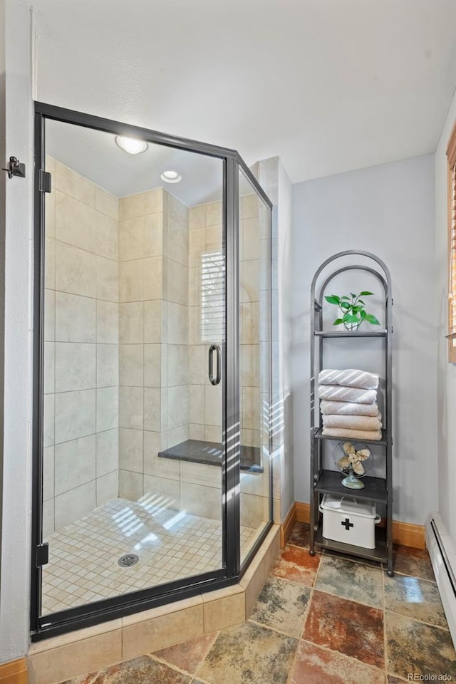 255 Kiowa Pl, Boulder, CO 80303 - full bathroom featuring a baseboard heating unit, baseboards, stone finish flooring, and a stall shower