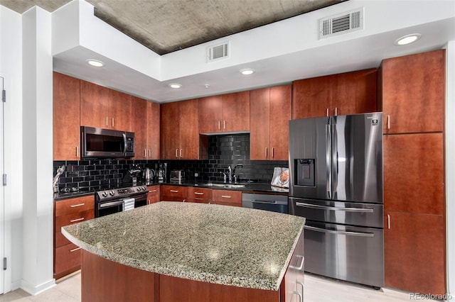 1700 Bassett St Unit 409, Denver, CO 80202 - kitchen with appliances with stainless steel finishes, a sink, dark stone counters, tasteful backsplash, and recessed lighting