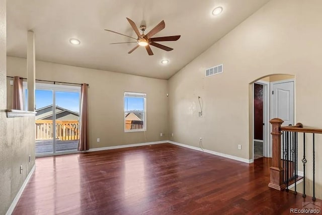 empty room with high vaulted ceiling, ceiling fan, and dark wood-type flooring